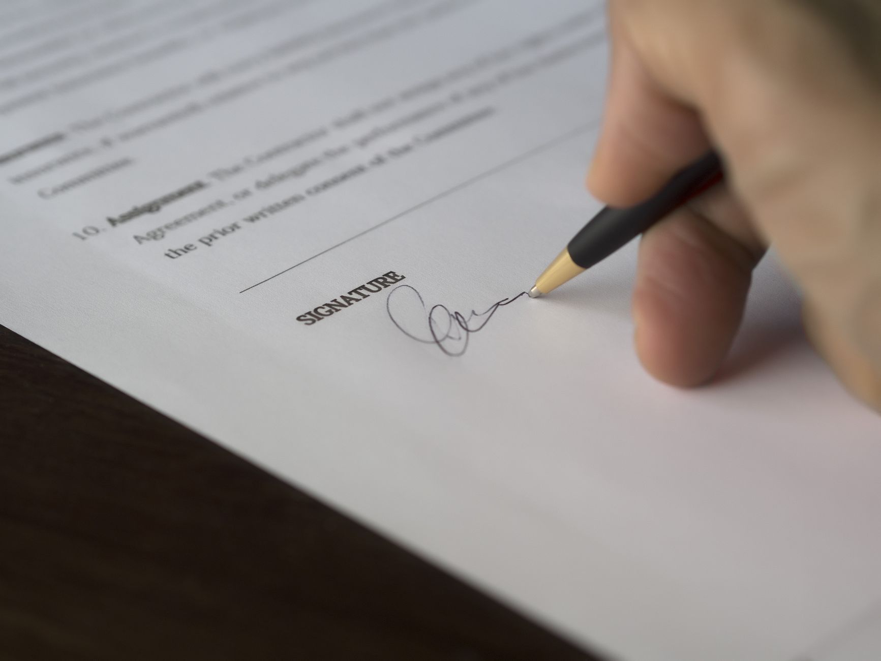 Close-up of a buyer signing an offer on a Florida waterfront home